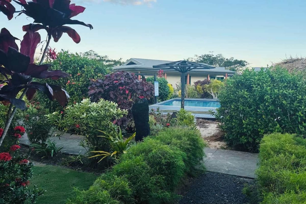 Deluxe Villa — the sitting area with desk and garden outlook