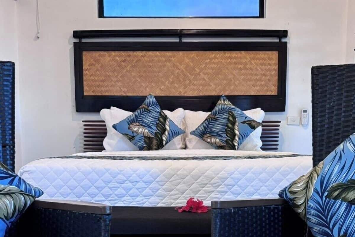 Luxury Villa — the separate bedroom with a king bed and bedside flowers