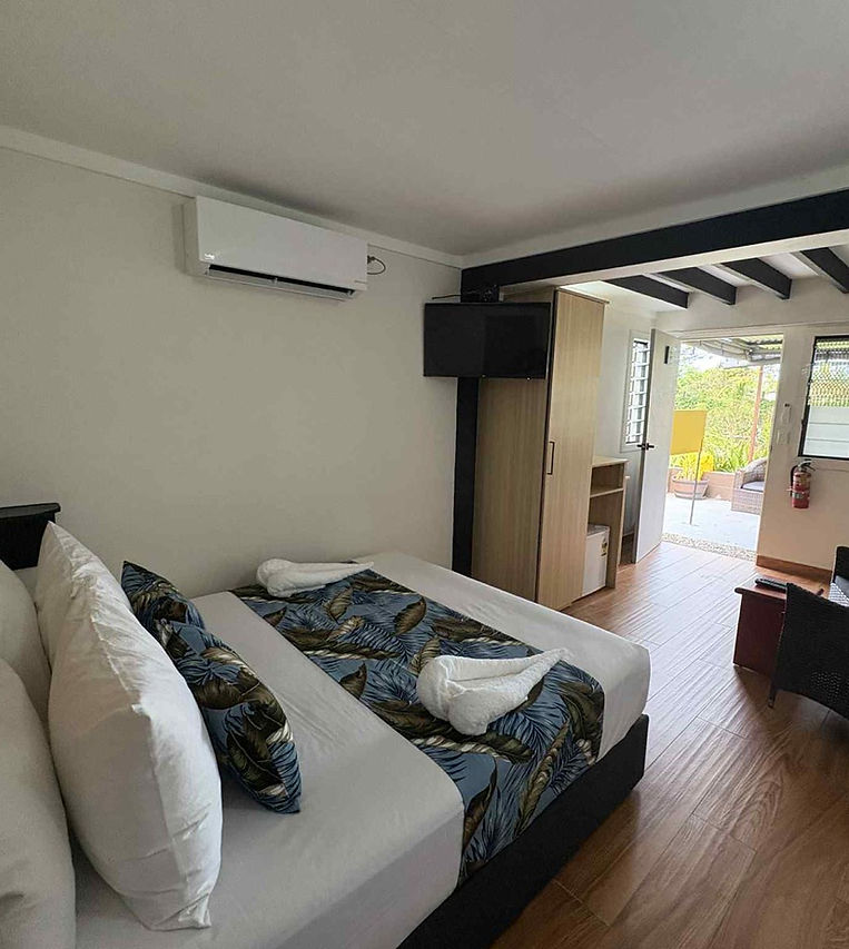 Standard Villa — the room styled for arrival, garden light through the window